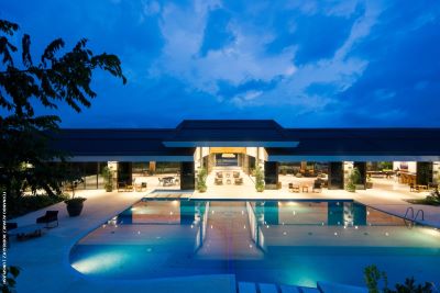 Large open-plan villa with pool at night