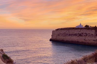 Chapel on promotory at sunset in Algarve